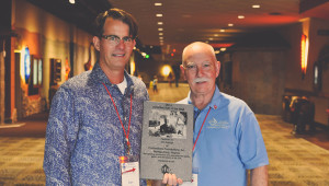 Friend and peer, Dan Bromley (left) accepts the award for Parrish during the 2014 Convention alongside Ed Sauter, Executive Director.