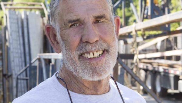 Buck Bartley smiles at the camera while at a job site.