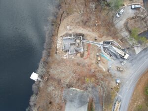 Aerial view of residential construction site with the foundation being poured.