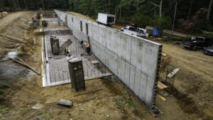 Concrete wall coming toward the camera in a construction site in a forest.