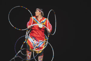 Native American woman performs traditional hoop dance.