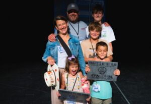 Russ Talpey and family pose with two Project of the Year Awards