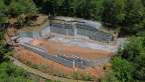 Aerial image of poured concrete walls for a building in the forest.