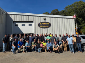 Carr team picture in front of Carr Concrete office building.