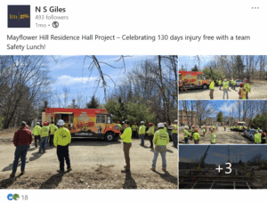Social media post from N S Giles. Text: Mayflower Hill Residence Hall Project - Celebrating 130 days injury free with a team Safety Lunch!" 14 construction workers in flourescent yellow and hard hats wait for lunch at a food truck. On the right side are previews of three more photos with a plus 3 at the bottom showing even more.