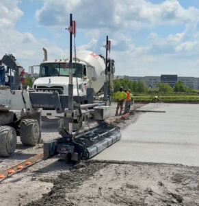 Screen machinery laying concrete pavement.