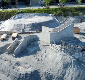White concrete walls and stairs built on a hill of ash.