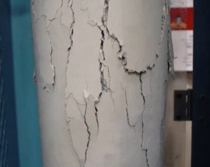 A cylinder of concrete with cracks in it.