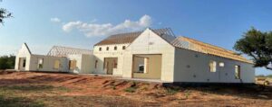 Concrete house in middle of field in building process